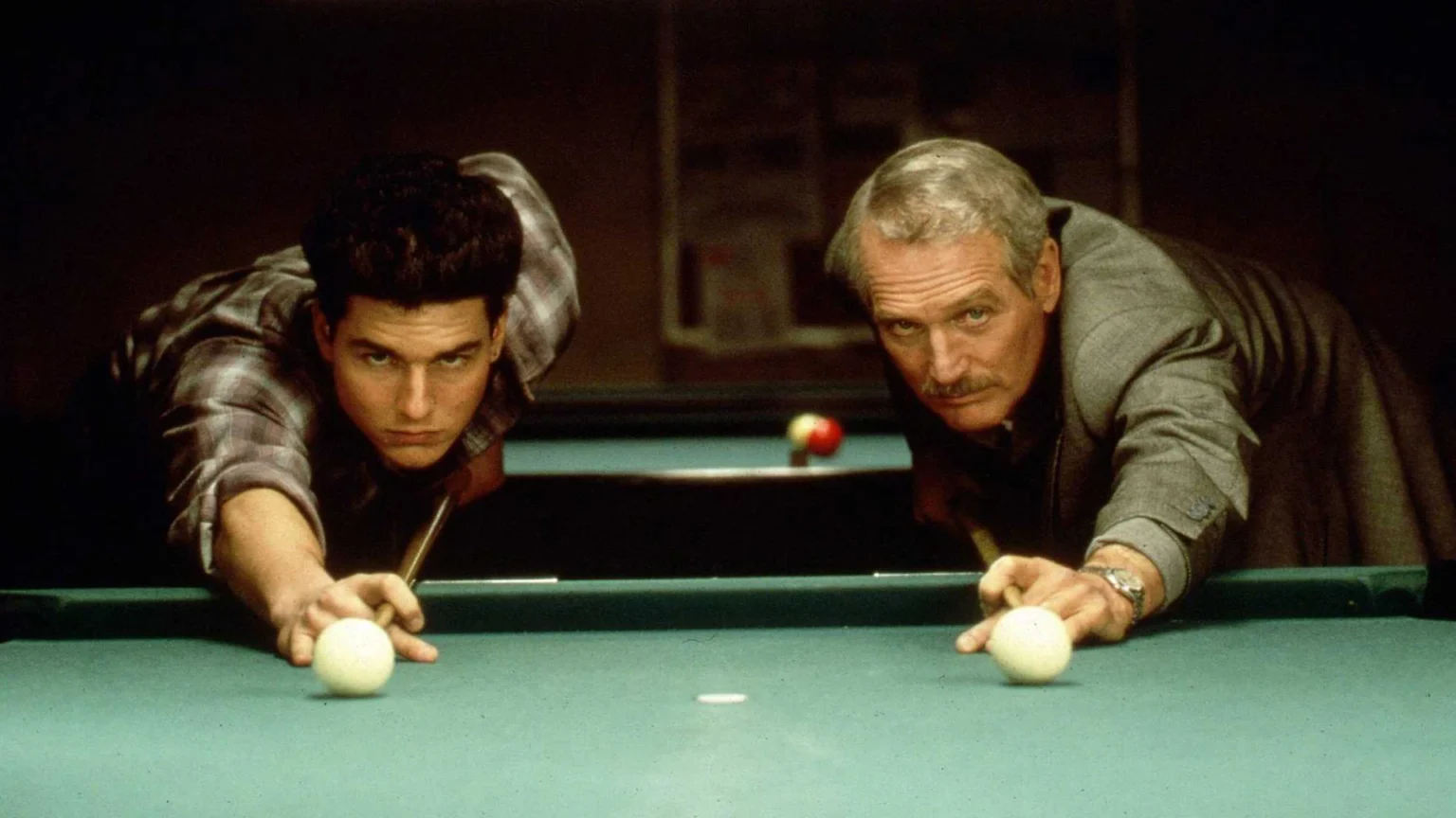 Promotional Still image from The Color of Money, with Tom Cruise and Paul Newman leaning over a pool table, with pool Cues drawn